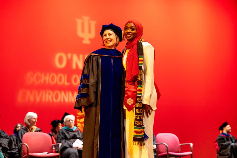 Dean Mooney and student in ceremonial robes